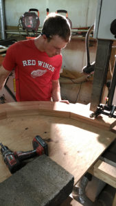 Apprentice Tim using the bandsaw to cut the mahogany curves to fit our custom doors.